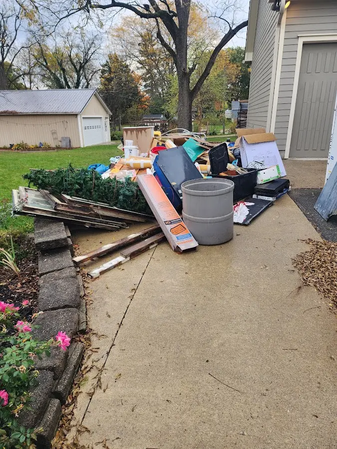 Dumpster being loaded with debris for Estate Cleanout Dumpster Rental in Norton